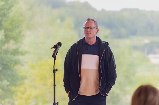 Dean standing in front of a microphone